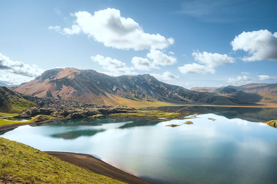 Landmannalaugar Rhyolite mountains surrounding a lake in the highlands in summer.