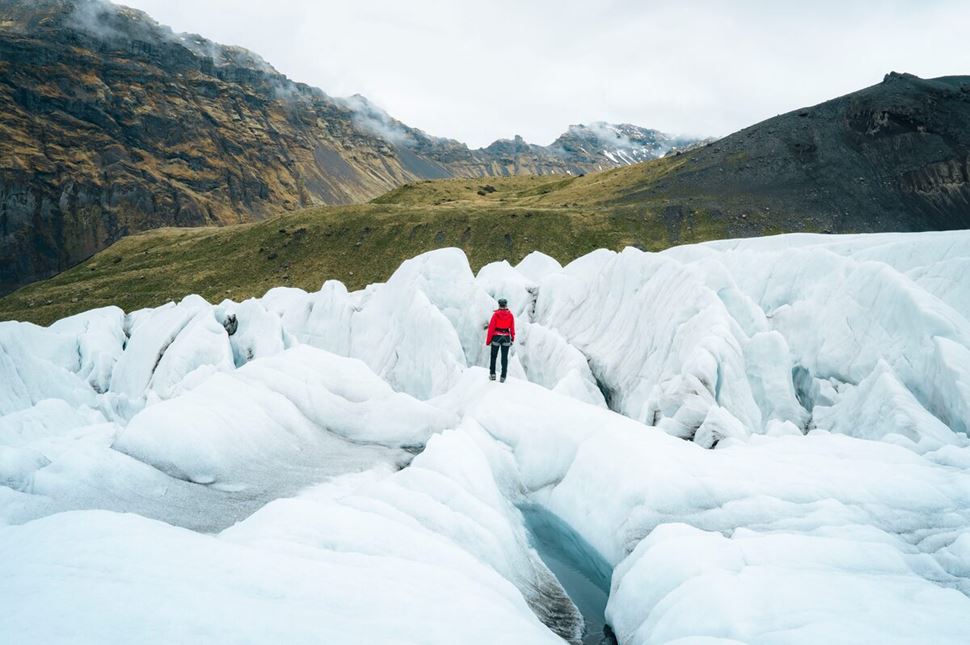 Tour guide hiking on Skaftafell glacier during a crevasse maze tour in summer.