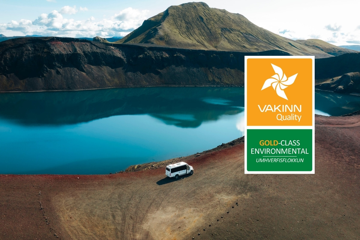 Arctic adventures tour bus at scenic Landmannlaugar landscape with gold vakin award.