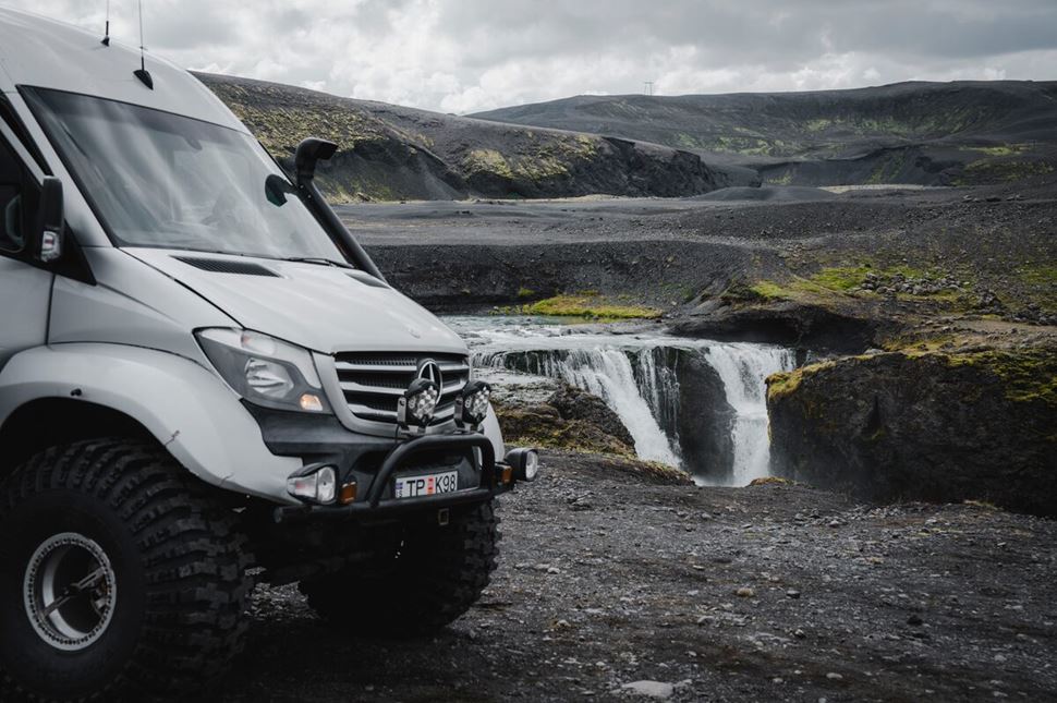 Silver Mercedes super jeep parked in Landmannalaugar landscape.