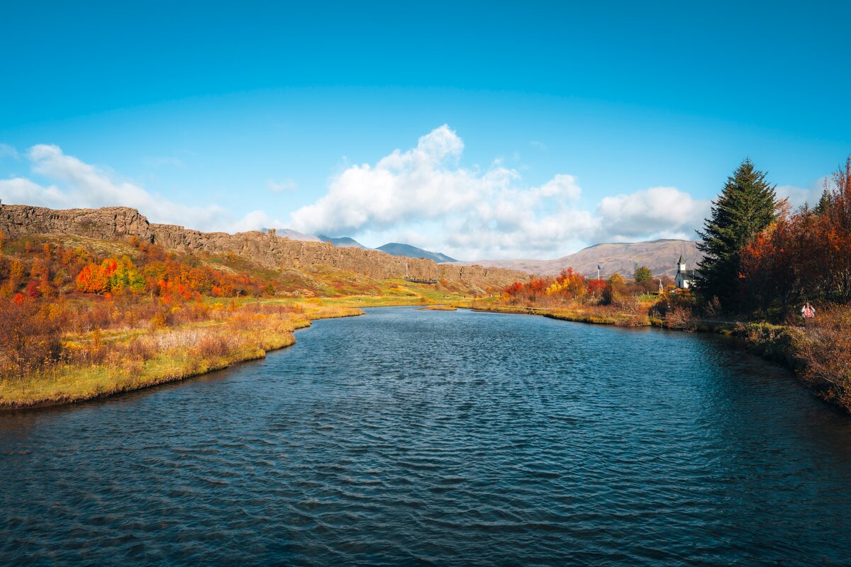 Landscape view of autumn foliage surrounding lake in Thingvellir National park.