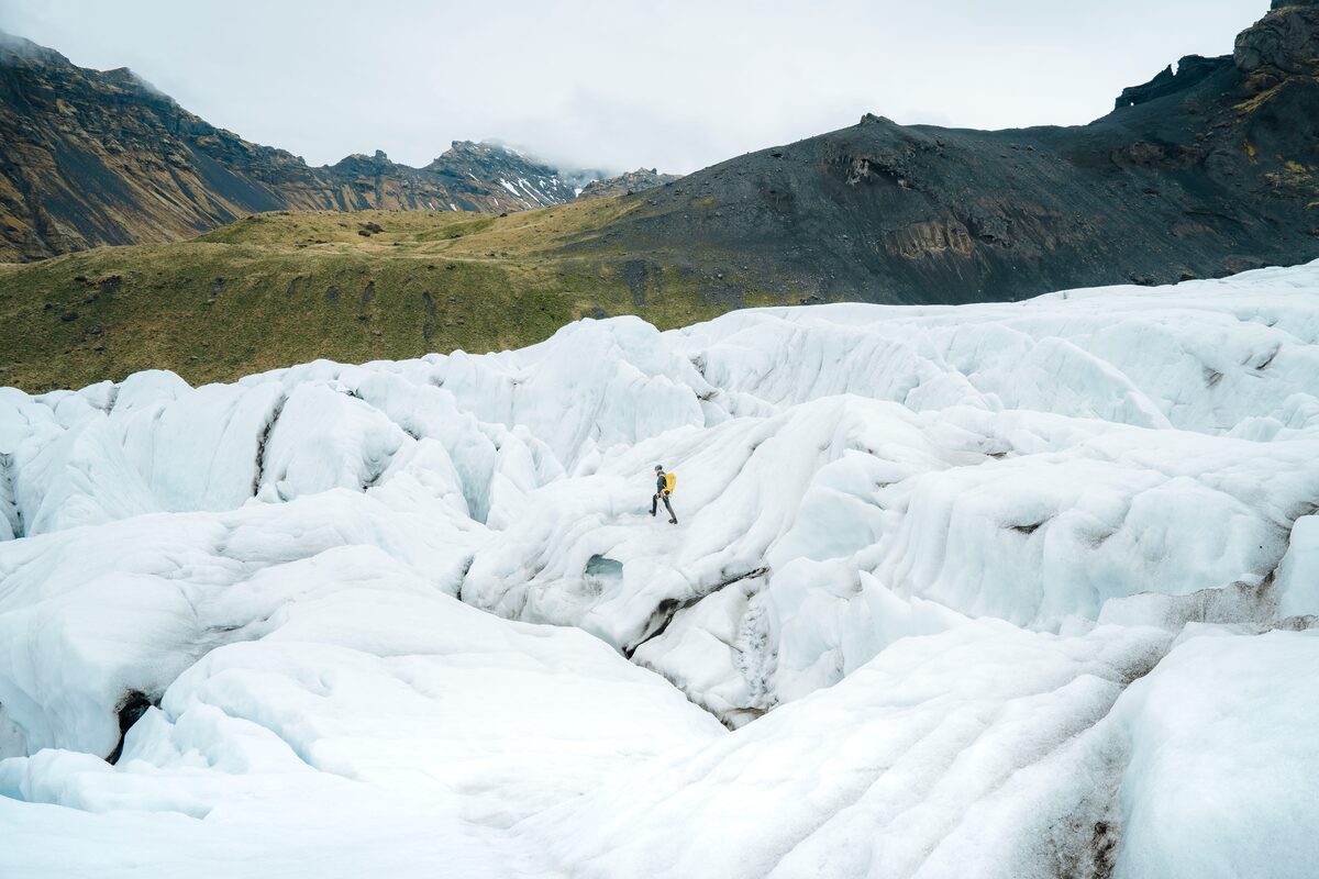 a person walking on a glacier in Skaftafell