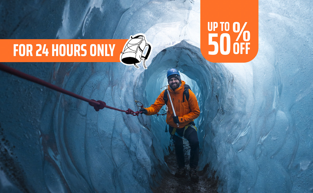 Male tourist exploring inside ice cave, singles day promotion 2025.