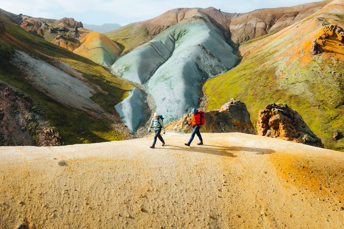 Two hikers exploring Graenihryggur in Landmannalaugar summer time.