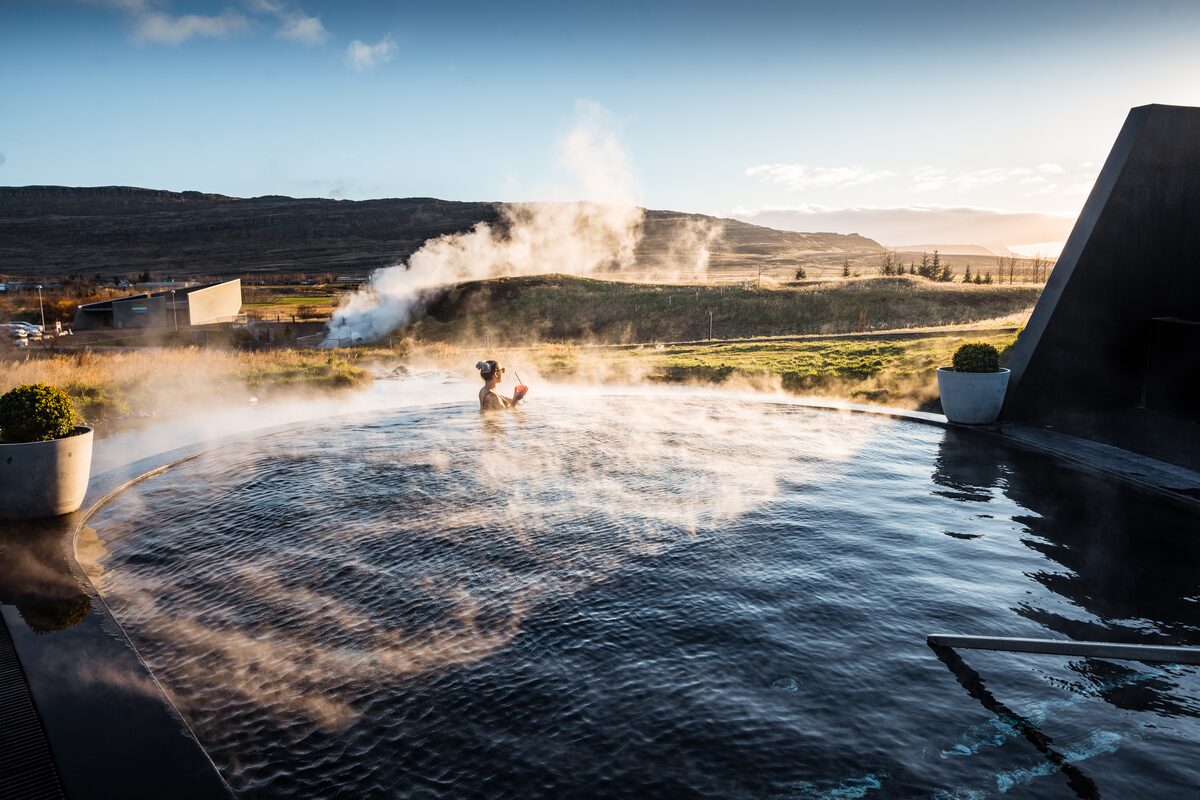 Lady bathing in Krauma geothermal baths, during Spring.