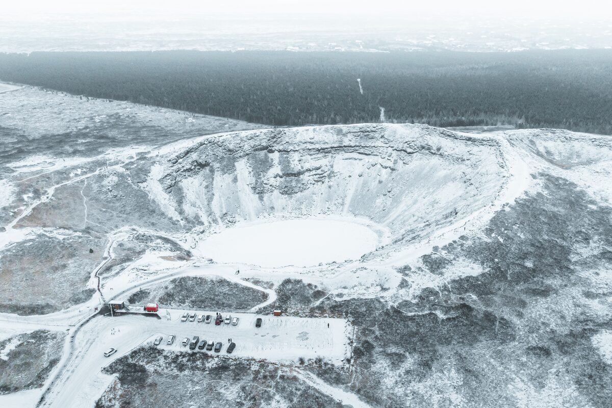 Kerid Crater And A Parking Lot Near It Covered In Snow in iceland