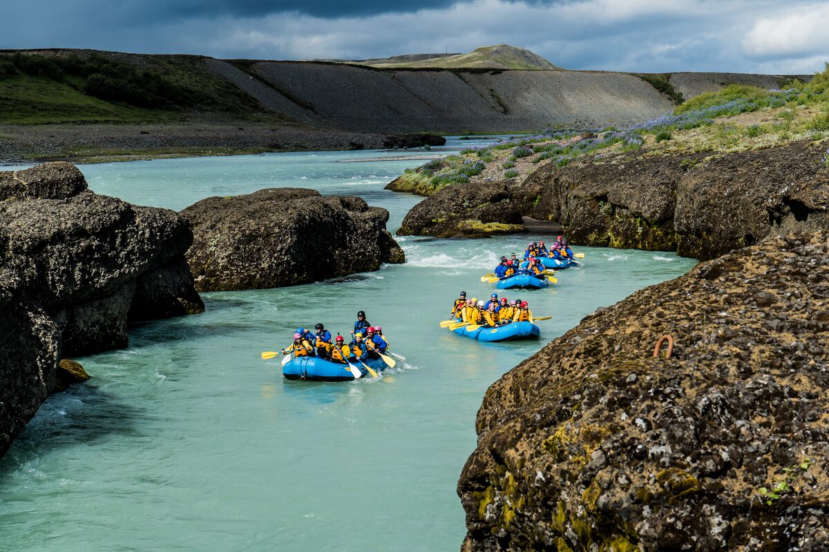 Small groups rafting down Hvita river in Golden Circle, Iceland.