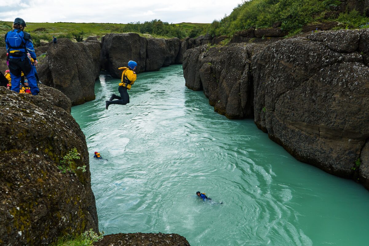 Tourist thrill seeking a jump intot he Hvita river in Iceland.