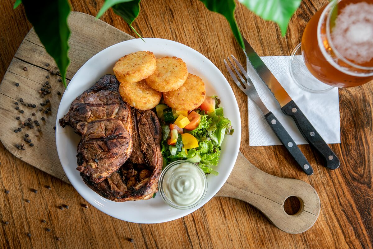Steak, potatoes and vegetable dinner.