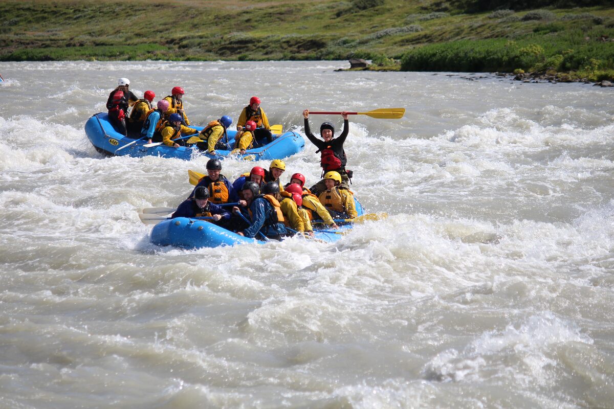 Two small groups rafting in the rapids of Hvita river in Golden Circle.