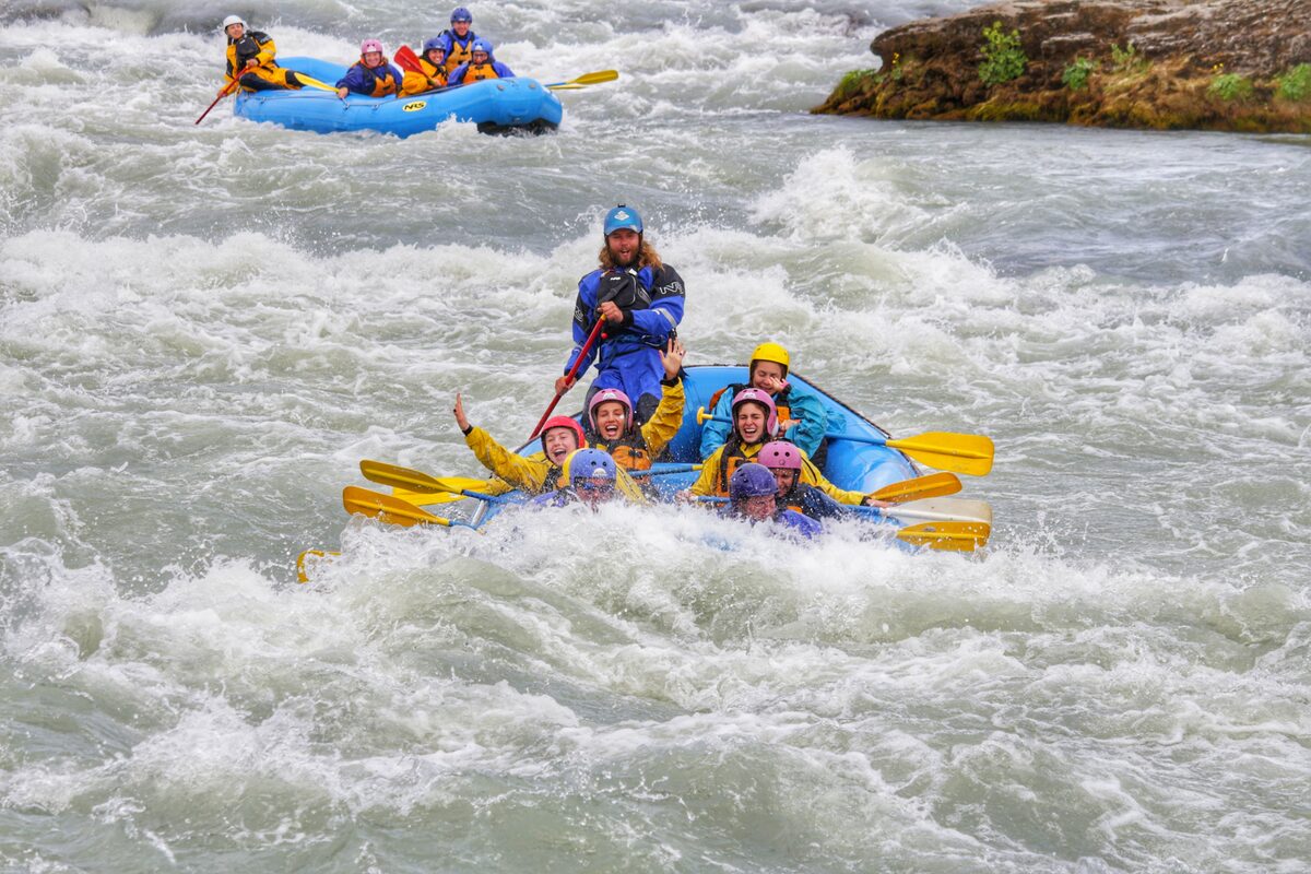 Tourists rafting in the rapids of Hvita river.