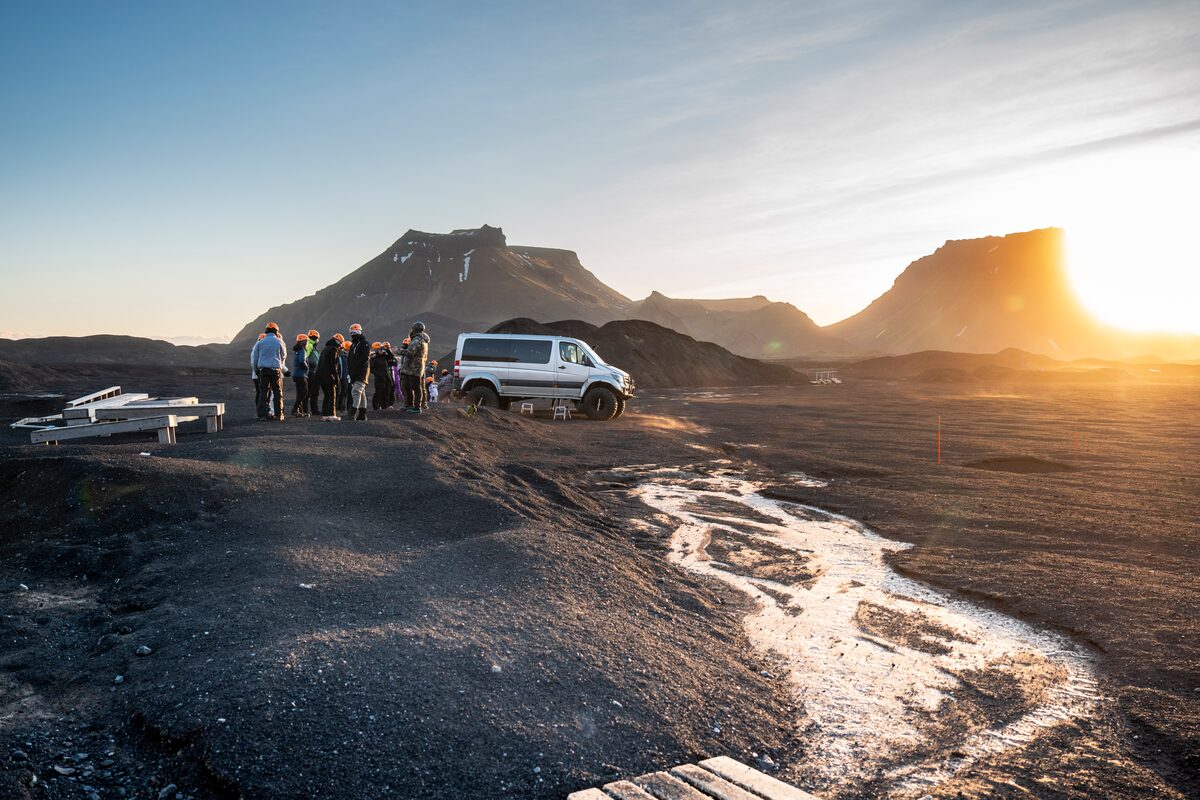 Silver super jeep outside Katla at Kotlujokull glacier outlet in Iceland during winter.