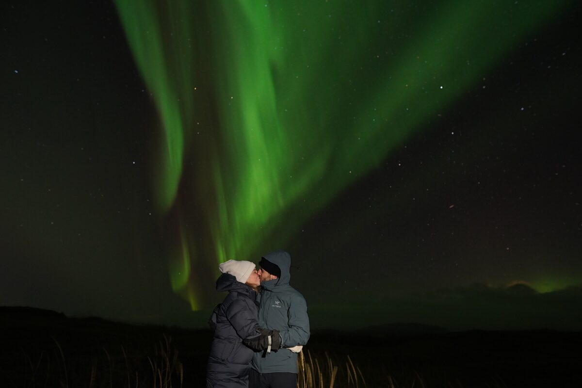 A Couple Kissing Under Northern Lights in iceland
