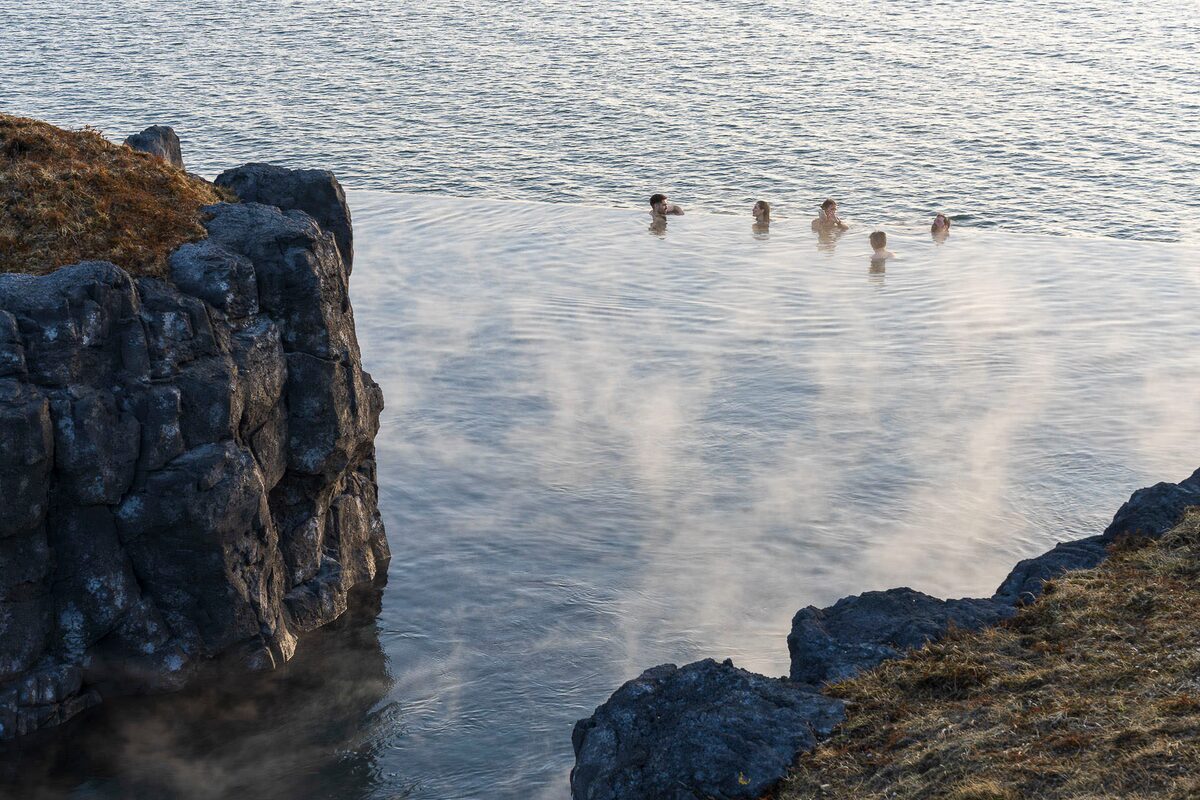 People Bathing In An Infinity Pool At Sky Lagoon in iceland