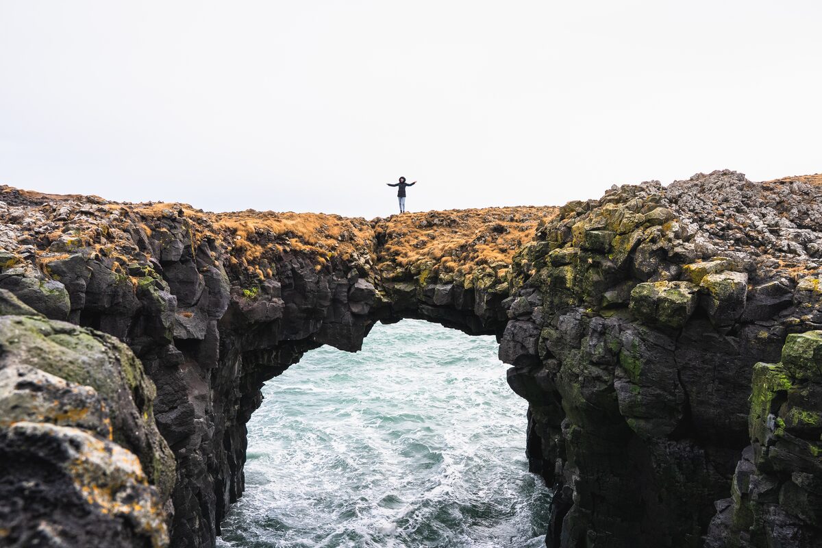 Woman Walking On Gatklettur Rock in iceland