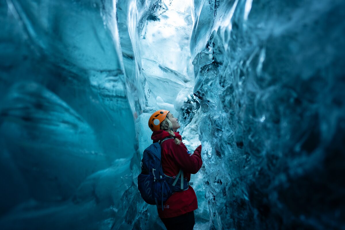 Woman In A Red Jacket At Crystal Ice Cave in iceland