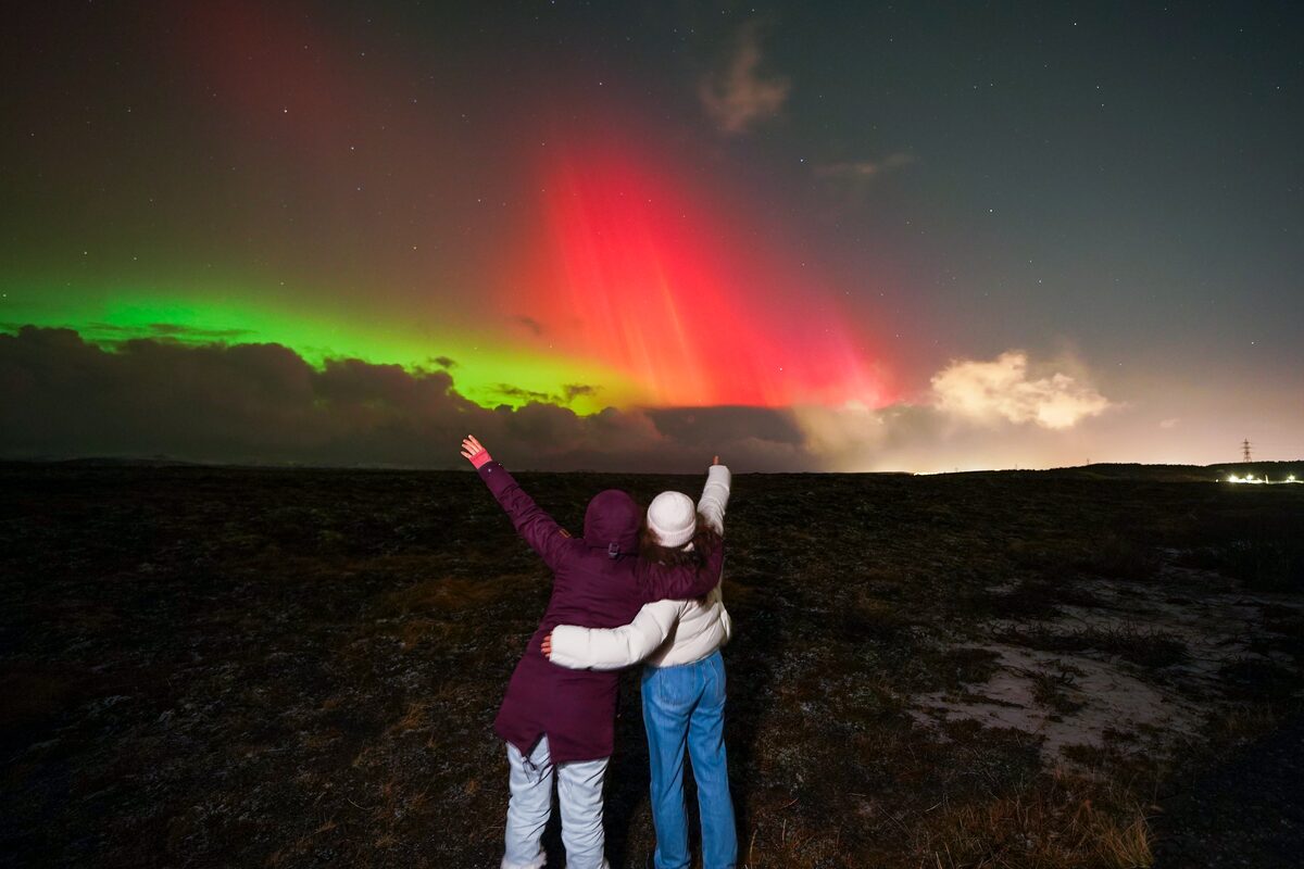 Two Ladies Enjoying The Northern Lights in iceland