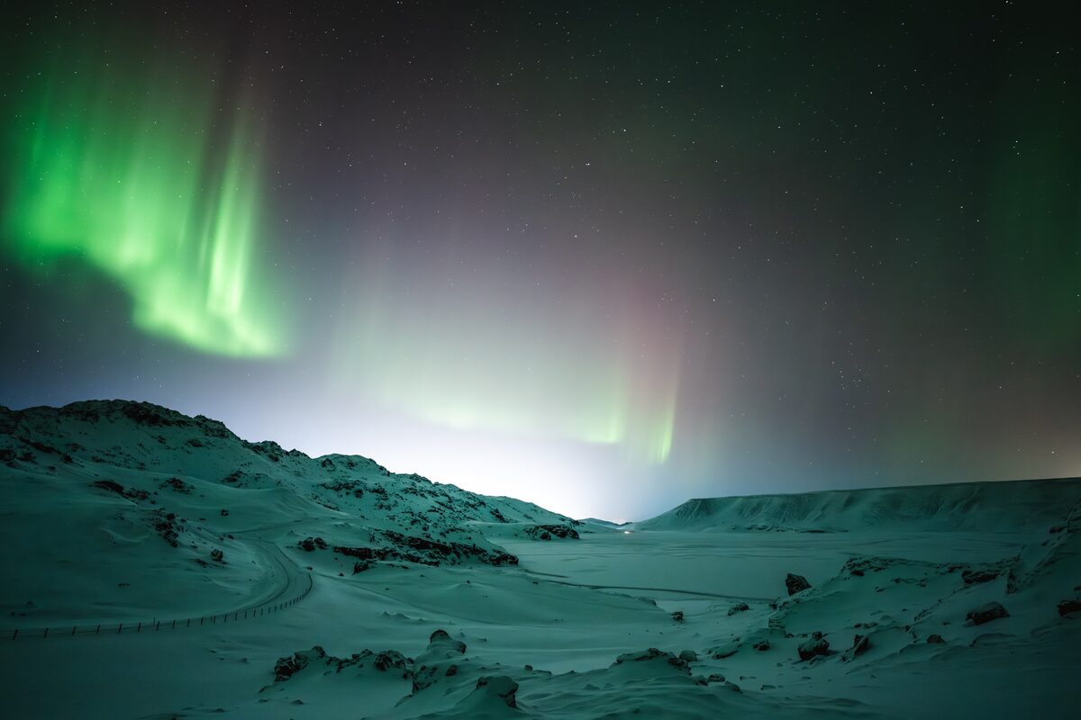 Photo of aurora display in a light-polluted area in Iceland.