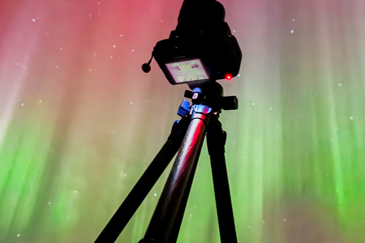 Tripod positioned low for stability while photographing the aurora.