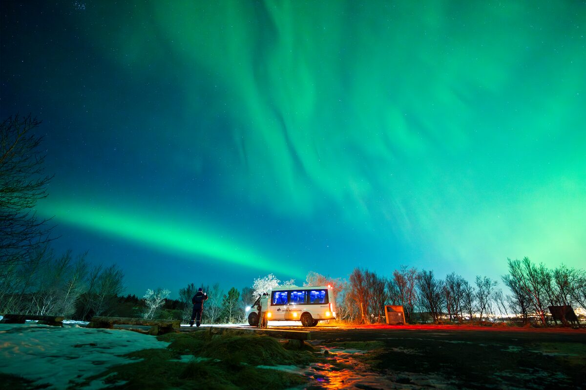  Aurora above the vehicle foreground lit softly without bright glare.