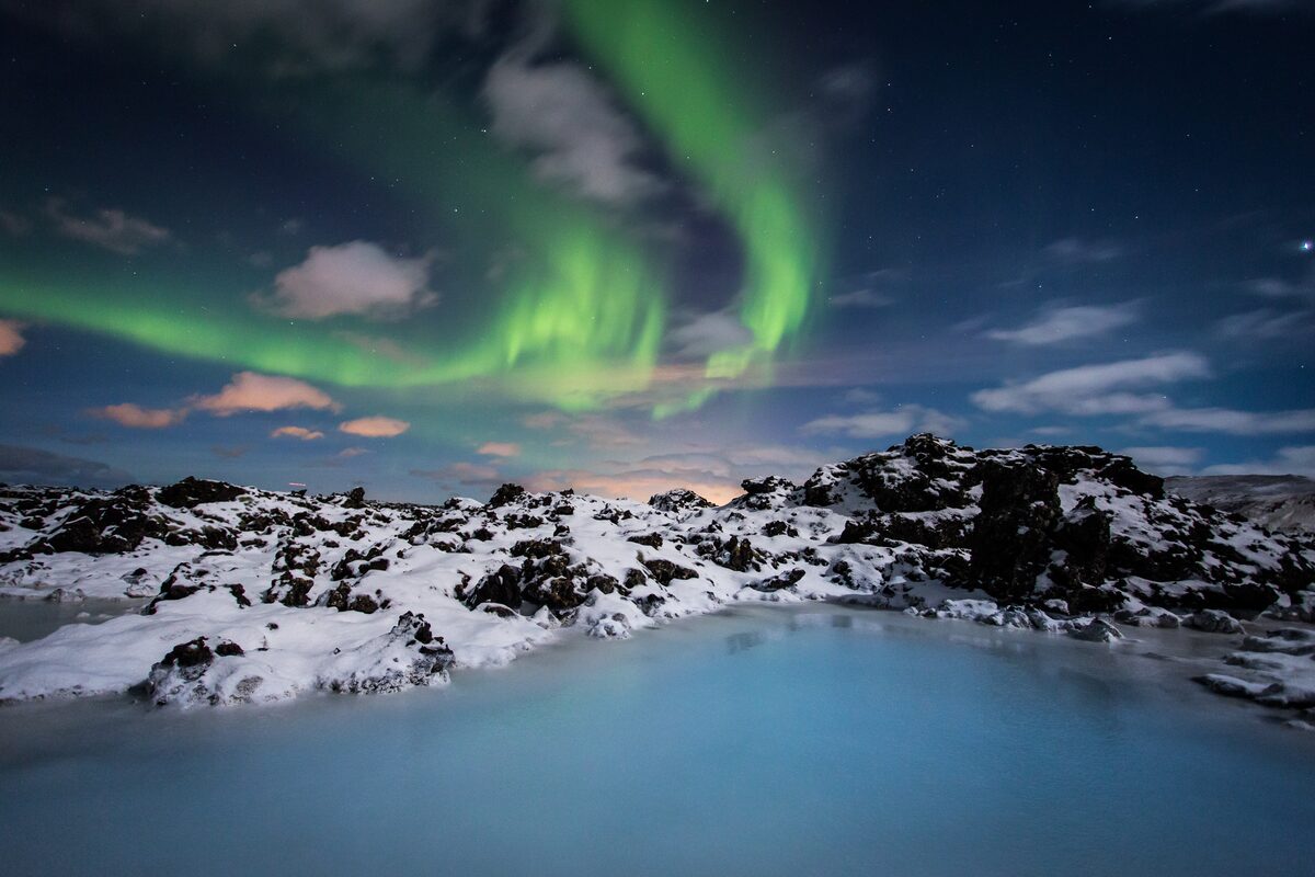 Blue Lagoon’s milky-blue water beneath the Northern Lights on the Reykjanes Peninsula in Iceland.