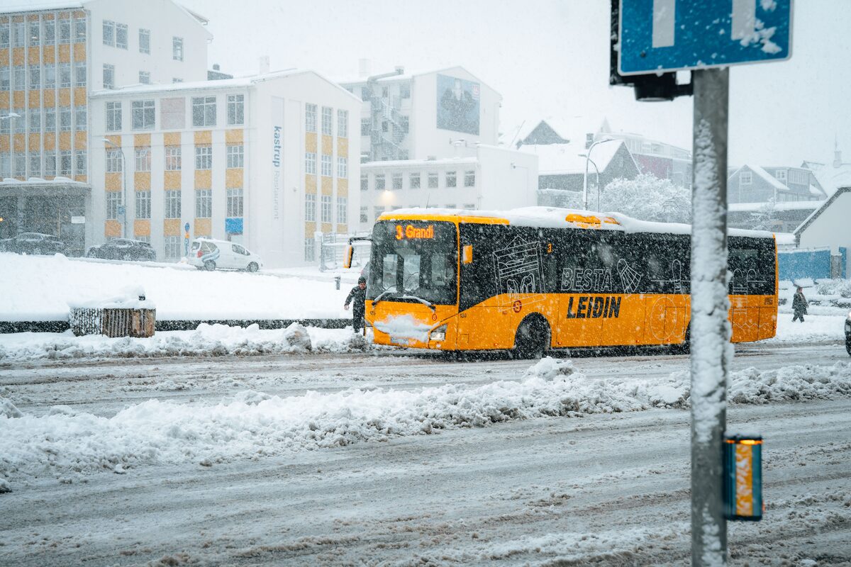 Public bus driving through heavy snow in Reykjavík. 