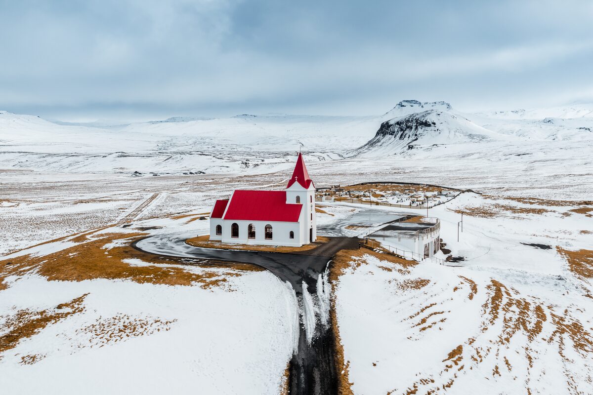 Ingjaldsholskirkja red roof church during winter time in Iceland.