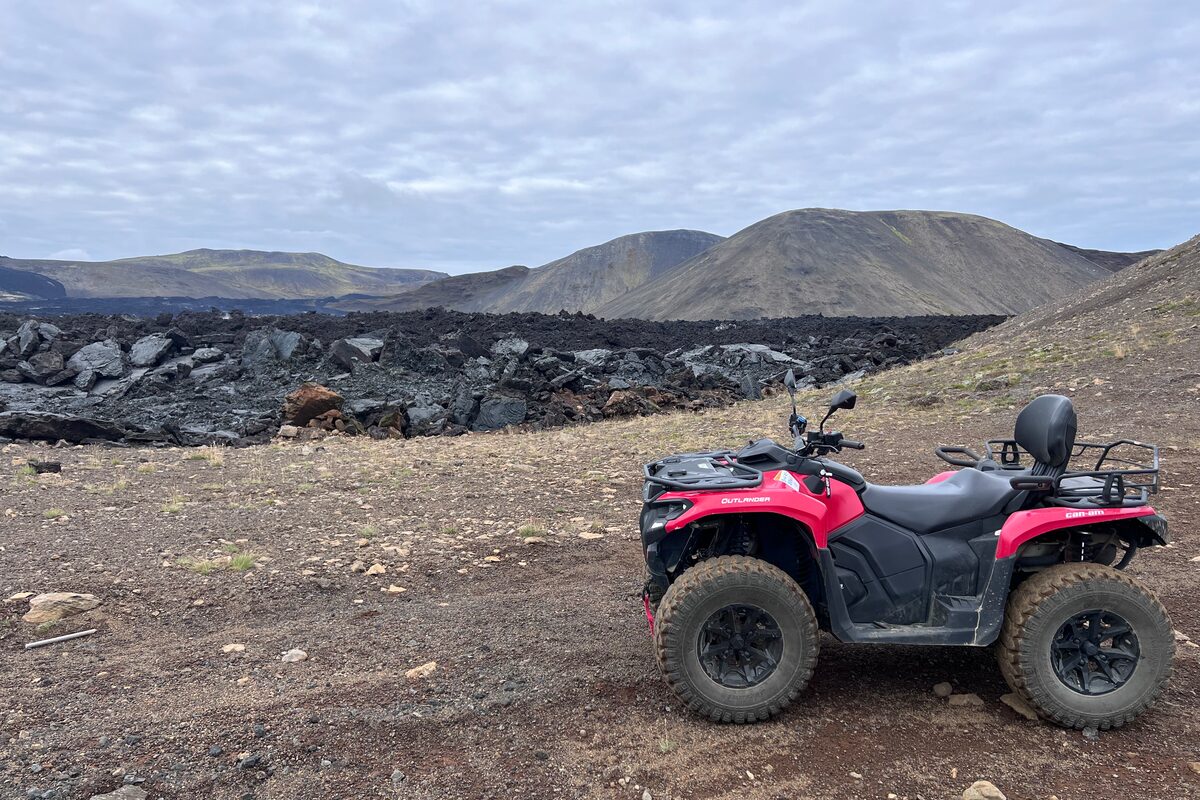 Pink Atv Standing Near Lava Formations in Iceland