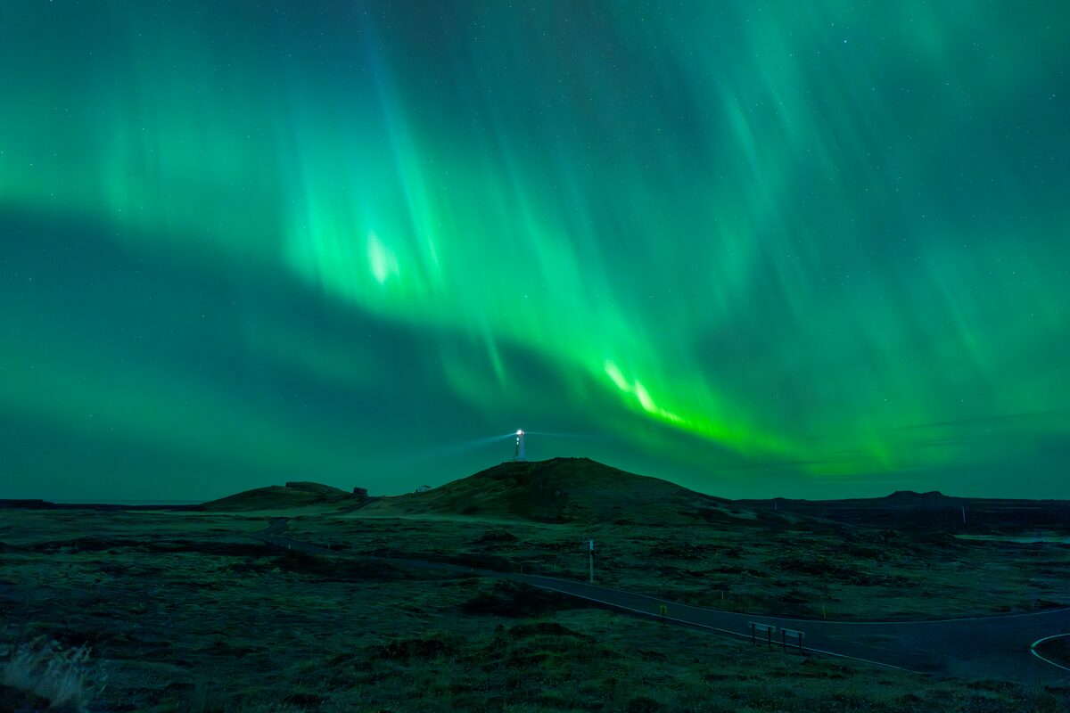 Northern Lights above lava fields on the Reykjanes Peninsula at night.