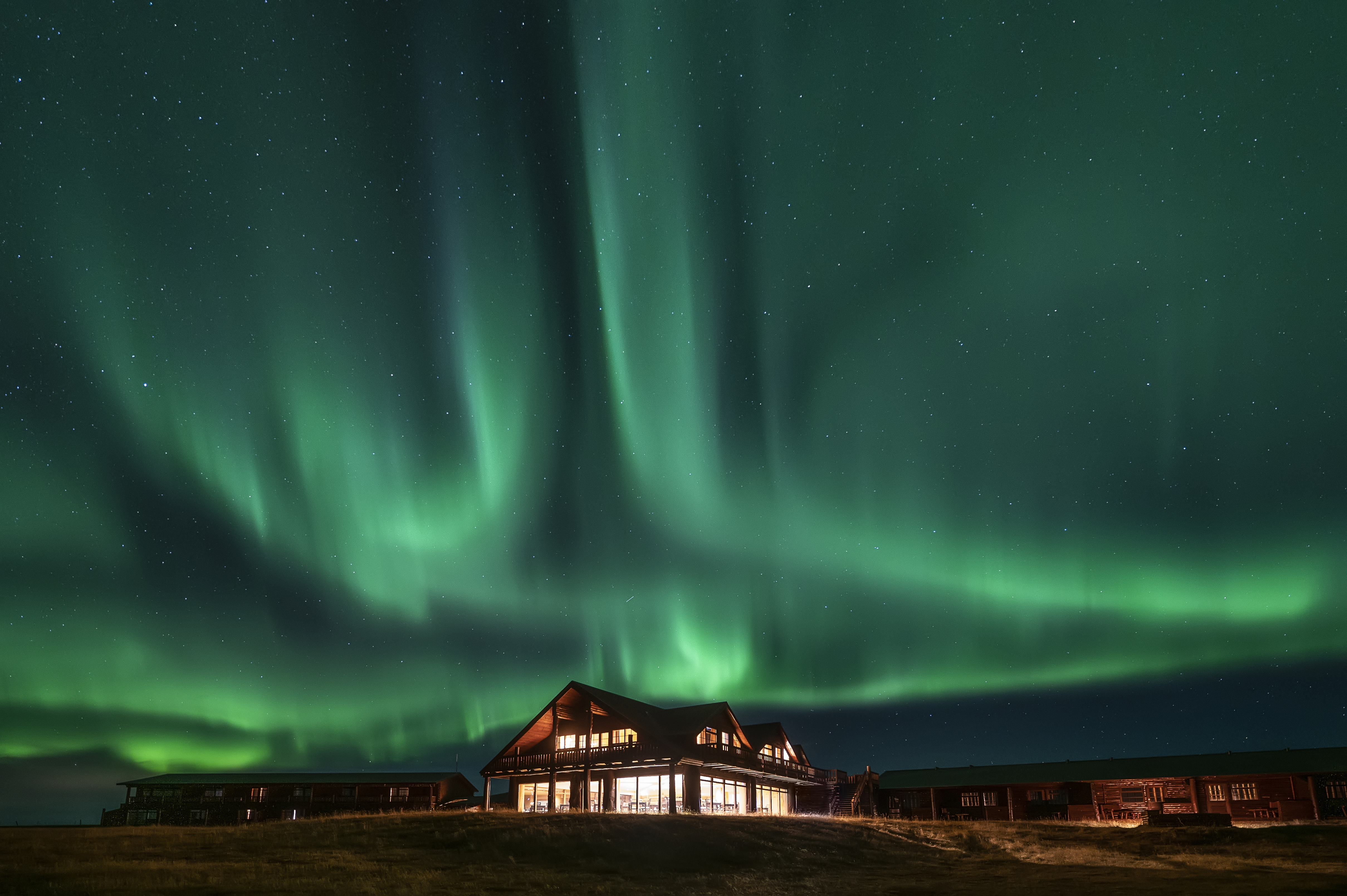 Hotel Rangá in South Iceland beneath the green Northern Lights.