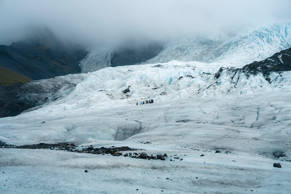 Dramatic distance landscape photo of Falljökull with clouds and mountains