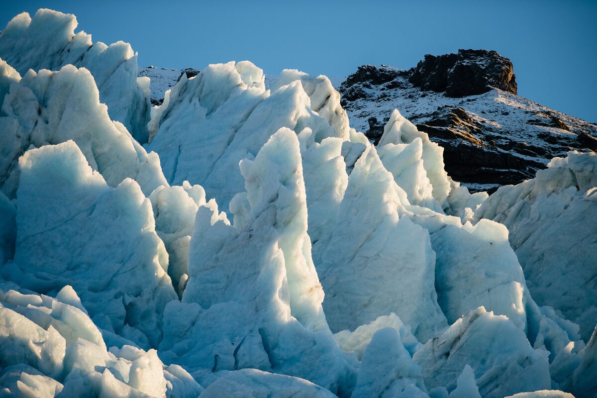 Dramatic jagged glacier features with mountain in background in Iceland