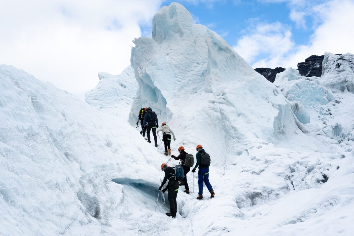 People Climbing An Ice Formation During Glacier Hike in Iceland