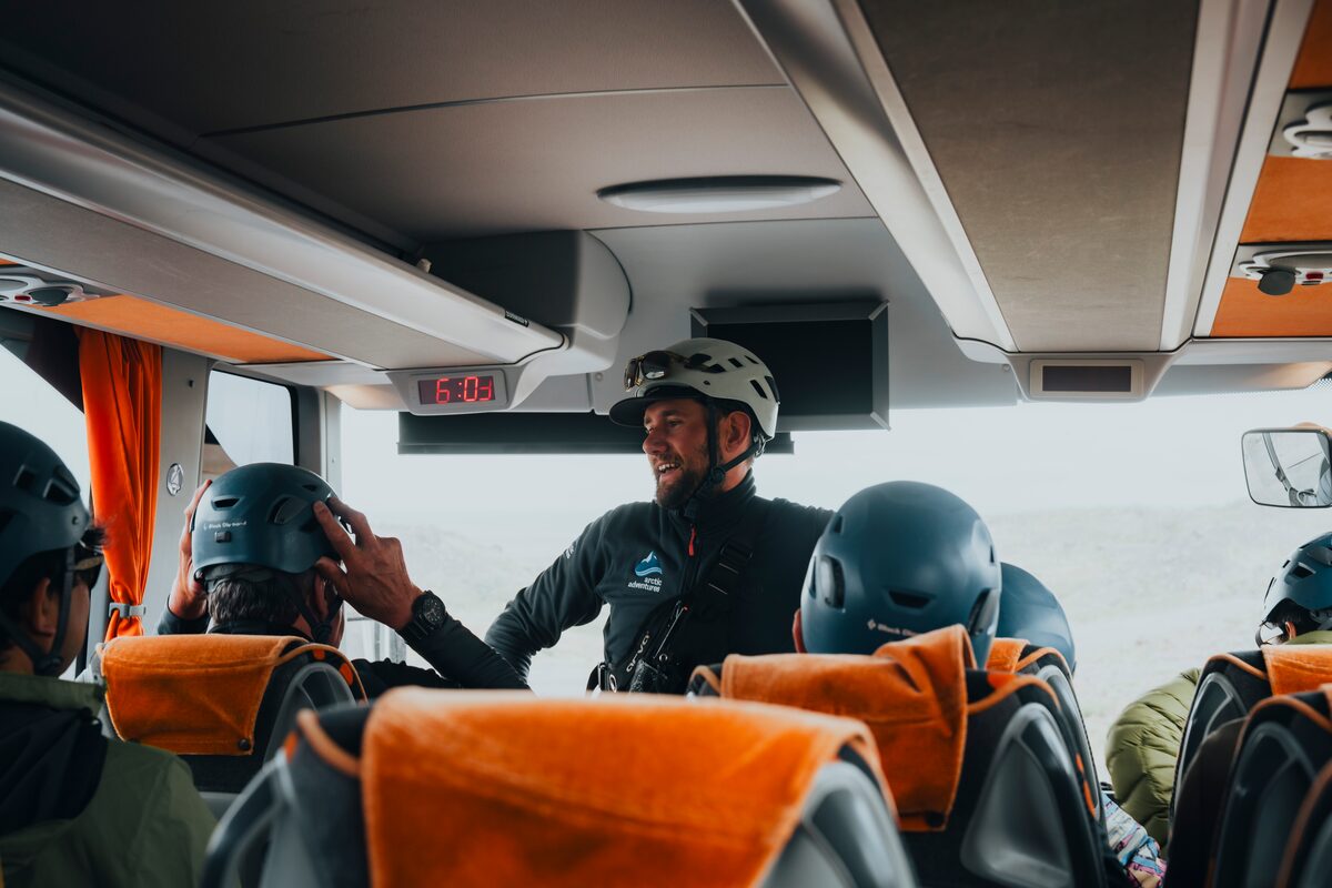 Guide talking to guests inside the 4x4 bus en route to the glacier