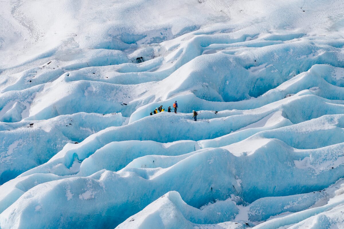 Overhead shot of guests walking among blue ice crevasses