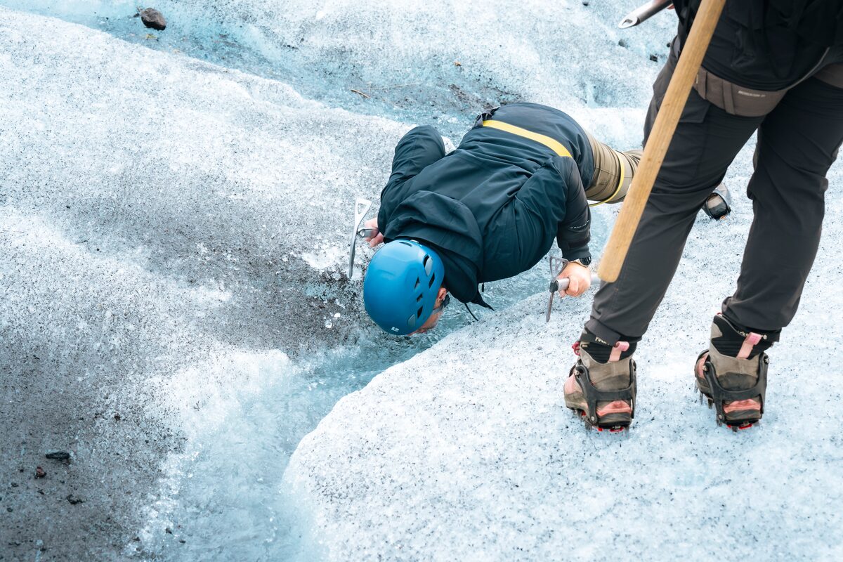 tourist drinking the crystal clear glacial water