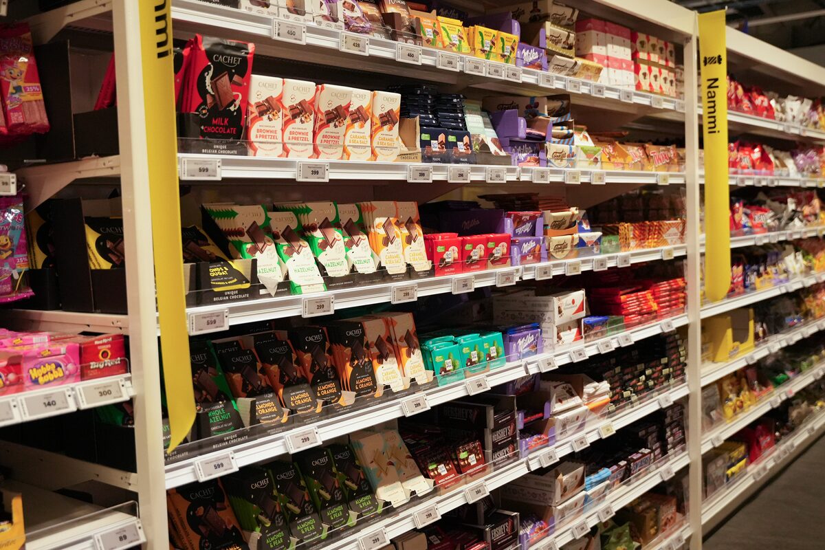 Supermarket aisle in Iceland fully stocked with chocolate bars and candy from local brands.