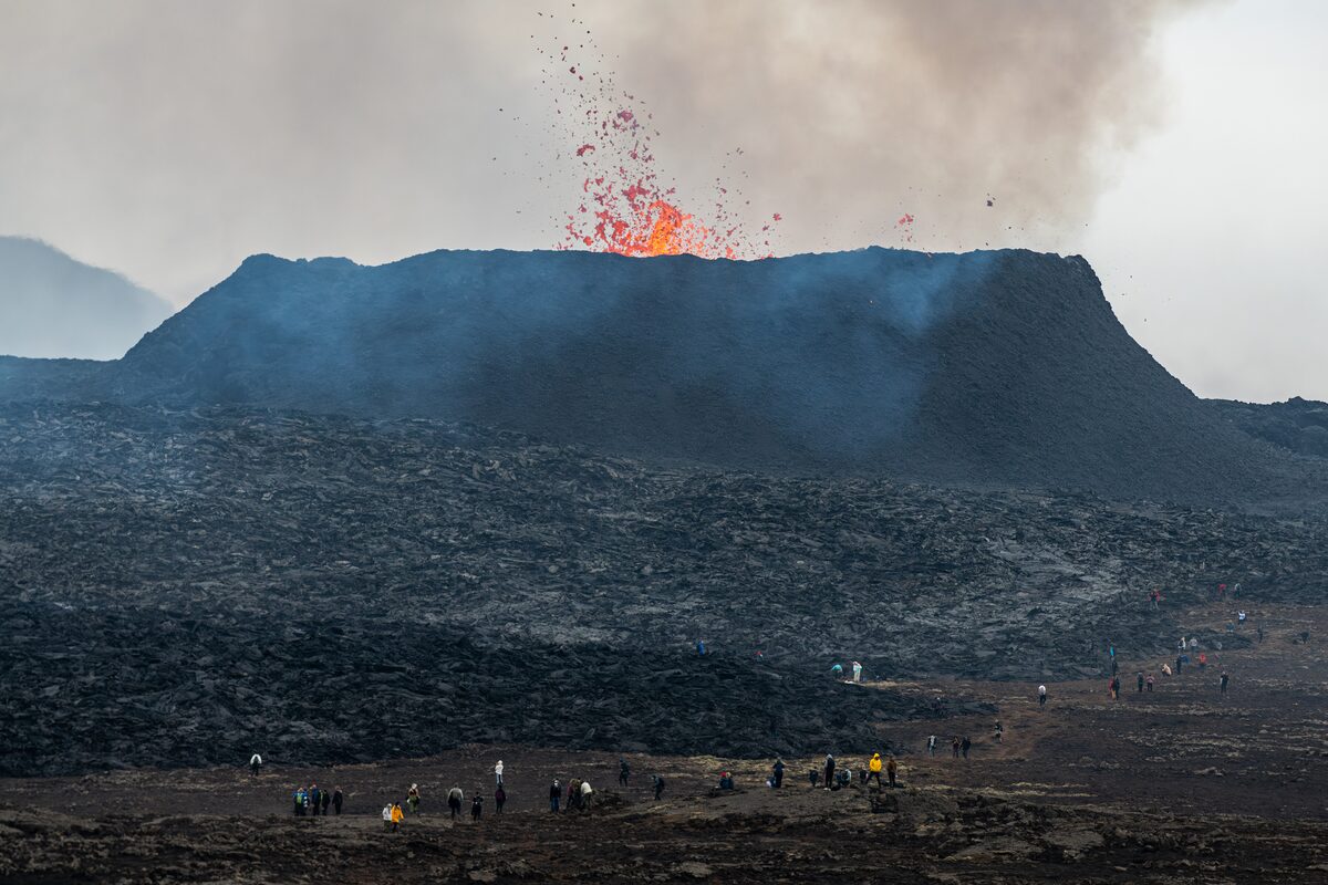 Crowds of visitors watching lava fountains erupt from the Litli-Hrútur cone on Iceland's Reykjanes Peninsula in 2023.