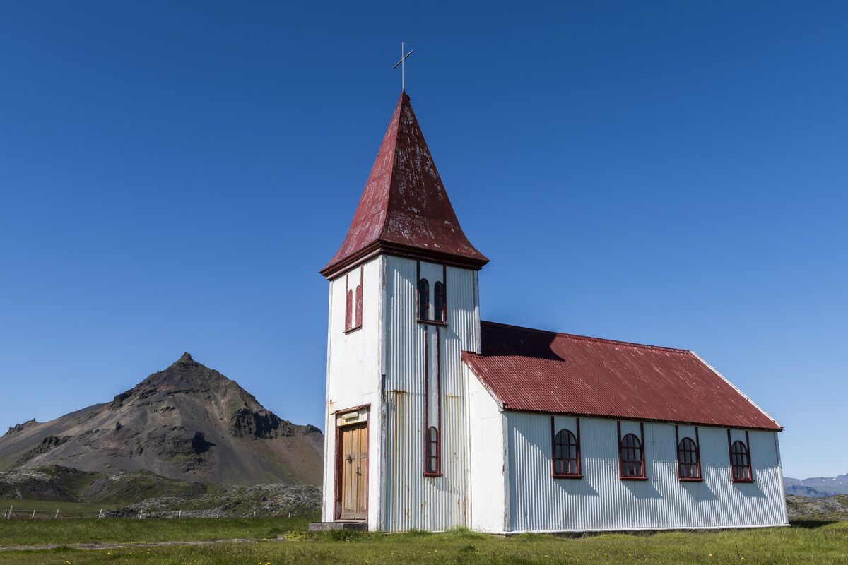 The hilltop Hellnar church with Stapafell mountain behind it, Snæfellsnes Peninsula, Iceland.