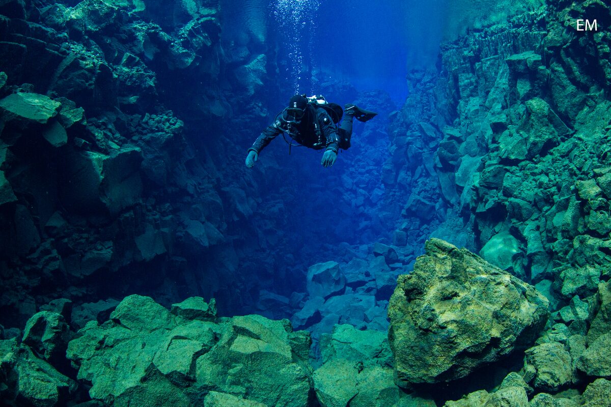 Diver Diving Down In Silfra in Iceland