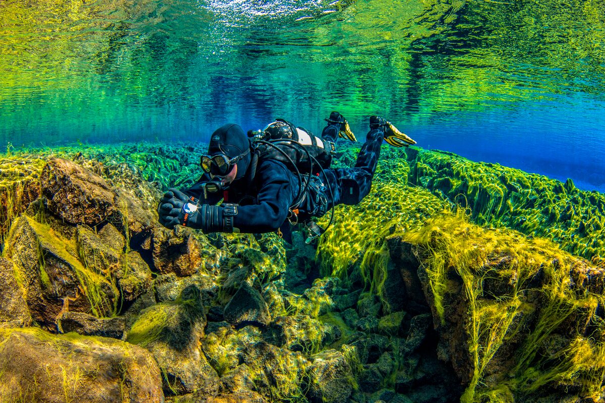 Diver In Green Silfra in Iceland