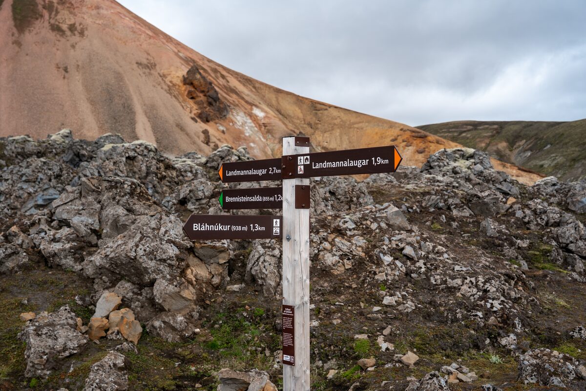 Wooden trail signpost with arrows to Landmannalaugar, Brennisteinsalda, and Bláhnúkur.