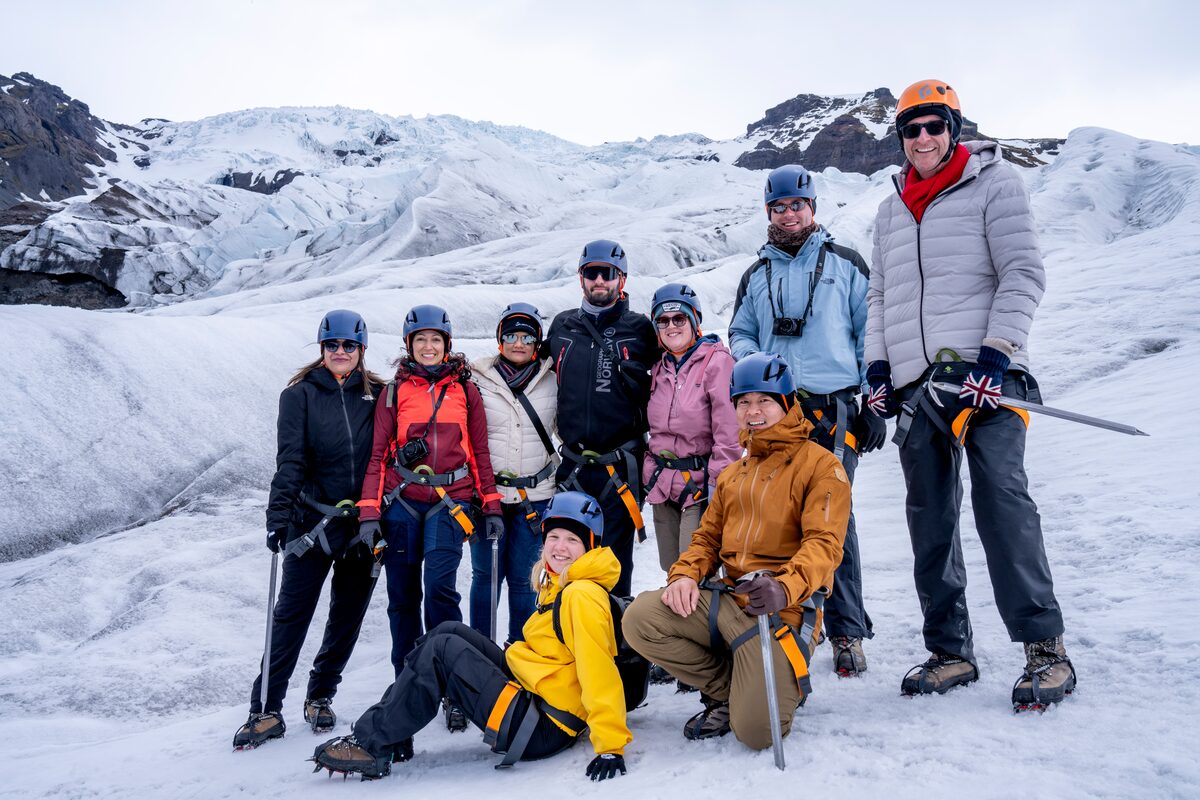 Arctic Adventures FAM trip group posing at Vatnajokull glacier.