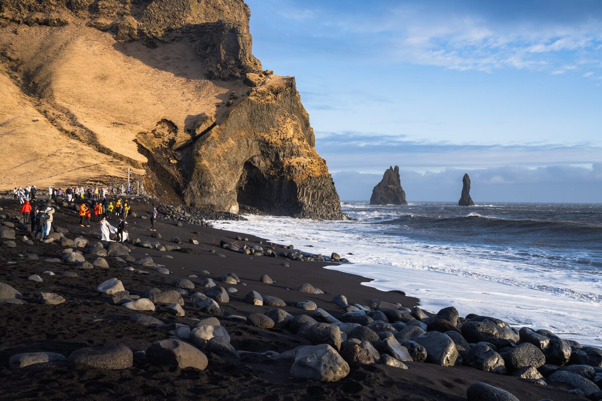Narrowed shoreline and strong waves at Reynisfjara after coastal erosion in February 2026, South Iceland.