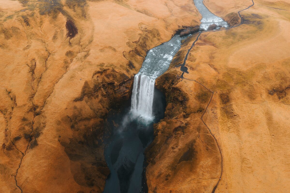 Aerial view of the Skógá river cutting through a deep gorge with one of the smaller cascades visible.