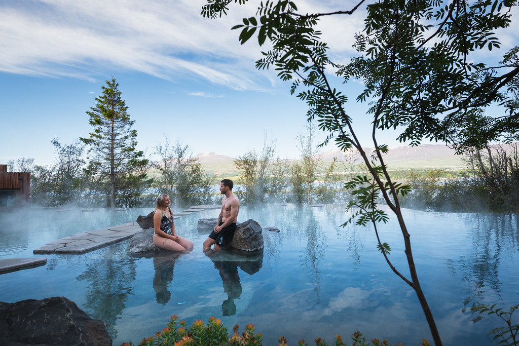 Couple Sitting In Forest Lagoon in Iceland