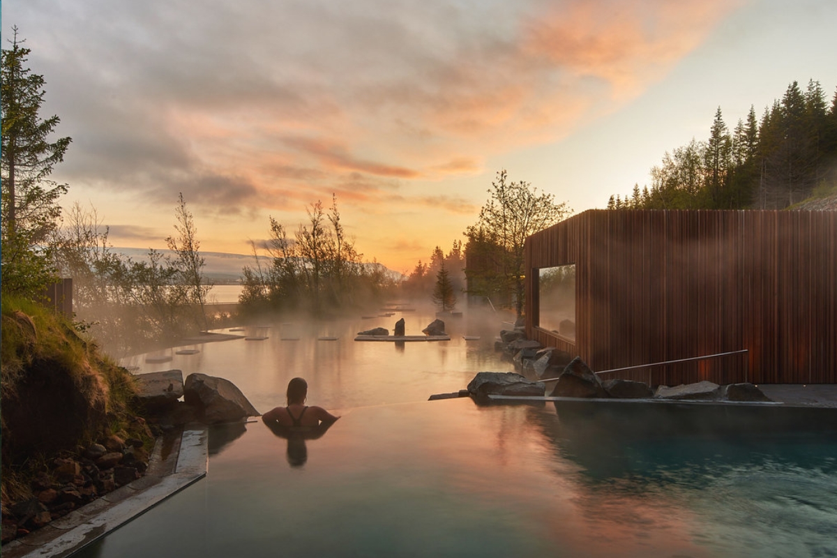 Woman At Forest Lagoon At Sunset in Iceland