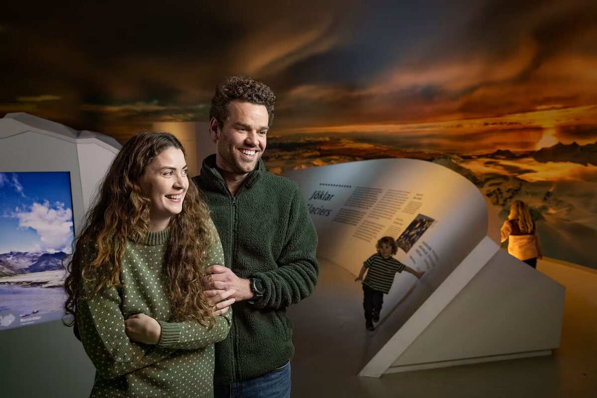 Couple Smiling At The Exhibition At Perlan in Iceland