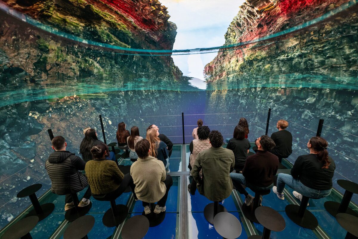 People At Perlan Looking At A Screen Showing Silfra in Iceland