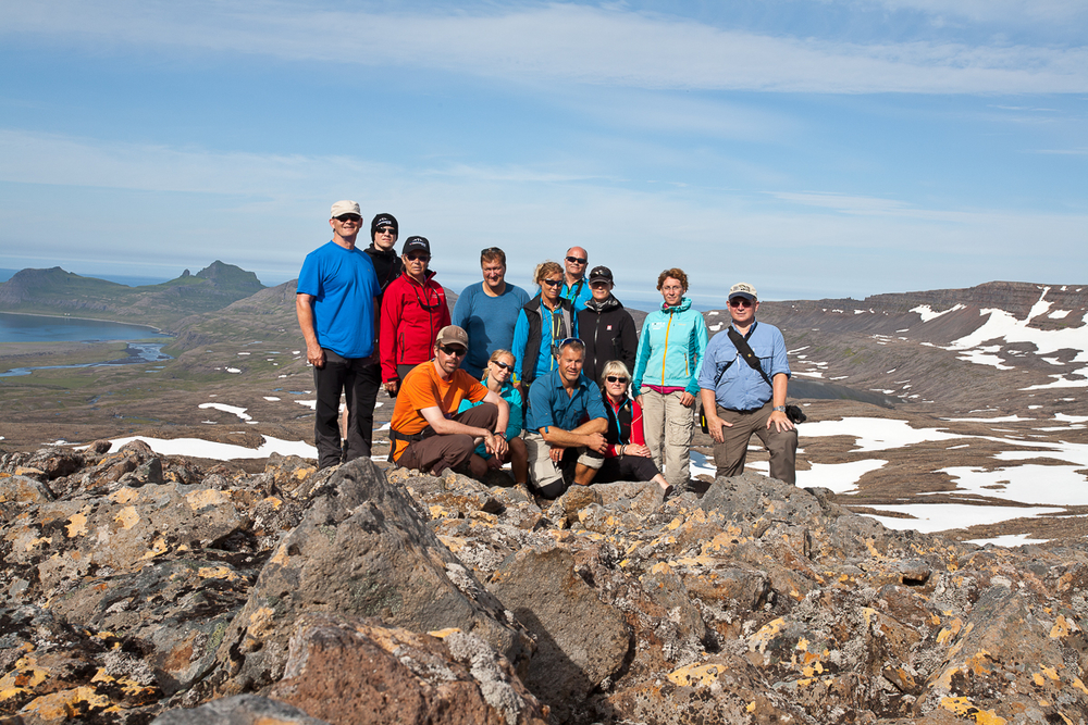 Group Of Hikers Standing On Rocky Ground Posing For A Picture in Iceland